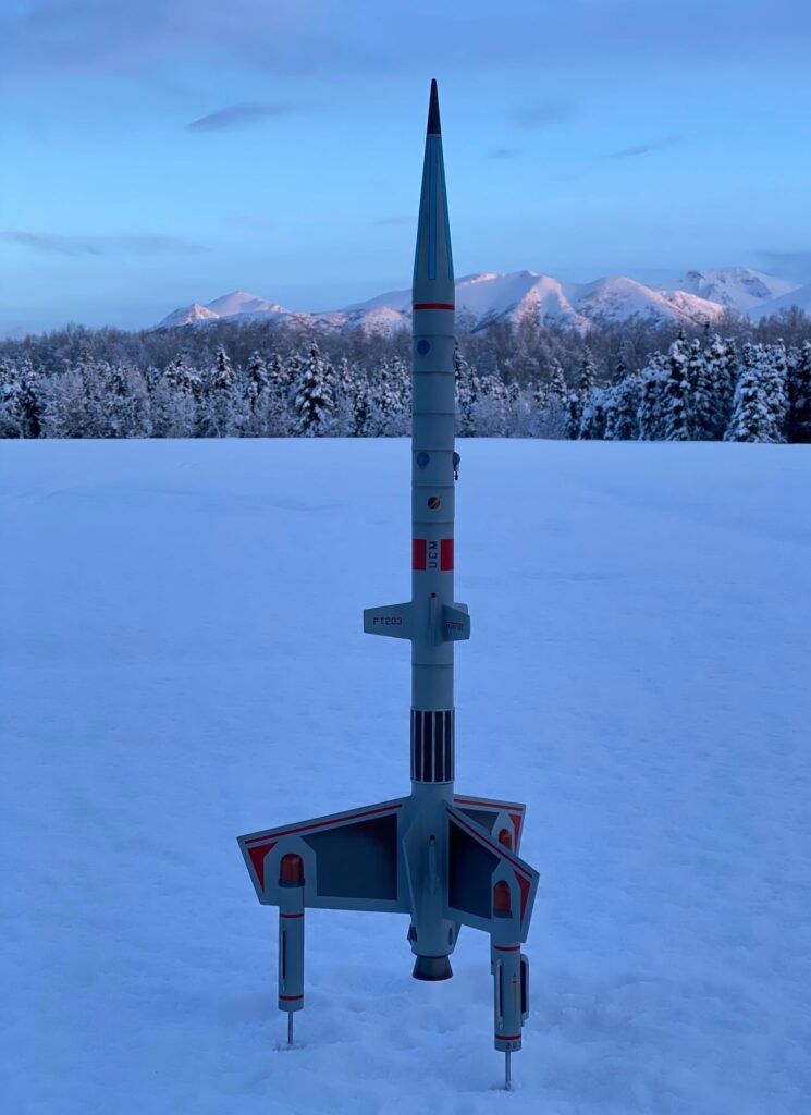 Starfire rocketship in front of mountains