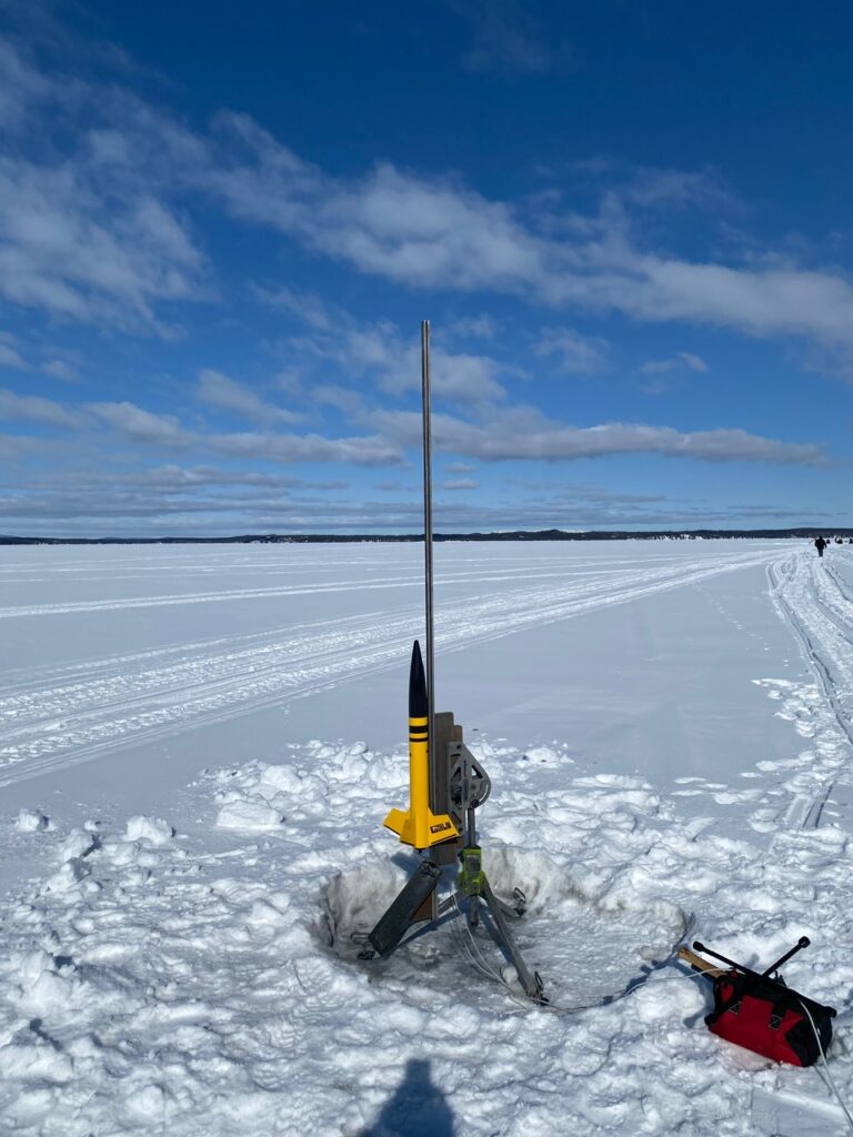 Mid-power rocket on launch pad on frozen lake
