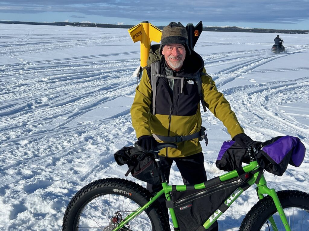 Man with rockets in backpack on snowbike